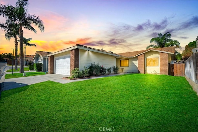 single story home with a yard and a garage