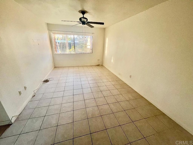 unfurnished room featuring light tile patterned floors and ceiling fan