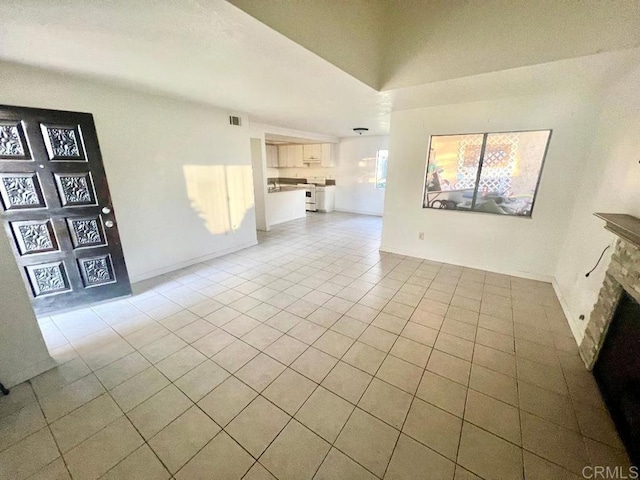 unfurnished living room featuring light tile patterned flooring