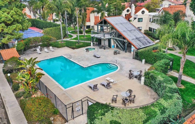 view of pool with a wooden deck and a patio area