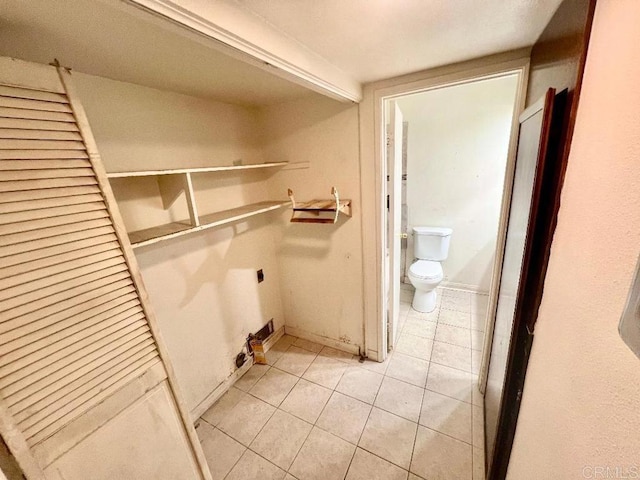 washroom with light tile patterned floors and electric dryer hookup