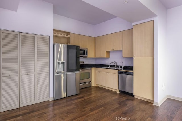 kitchen with dark wood-type flooring, sink, light brown cabinets, and stainless steel appliances