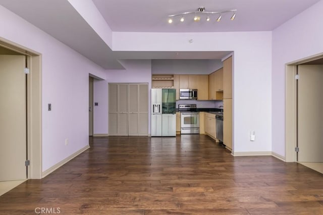 kitchen with light brown cabinetry, appliances with stainless steel finishes, and dark hardwood / wood-style flooring