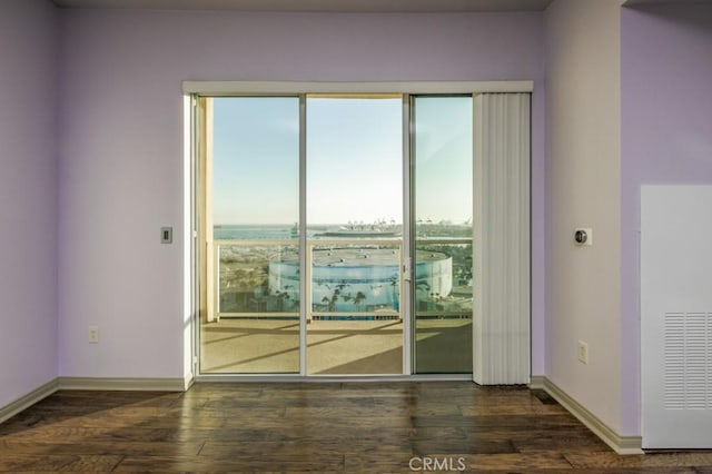 unfurnished room featuring dark wood-type flooring