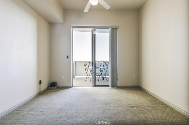 carpeted spare room with ceiling fan