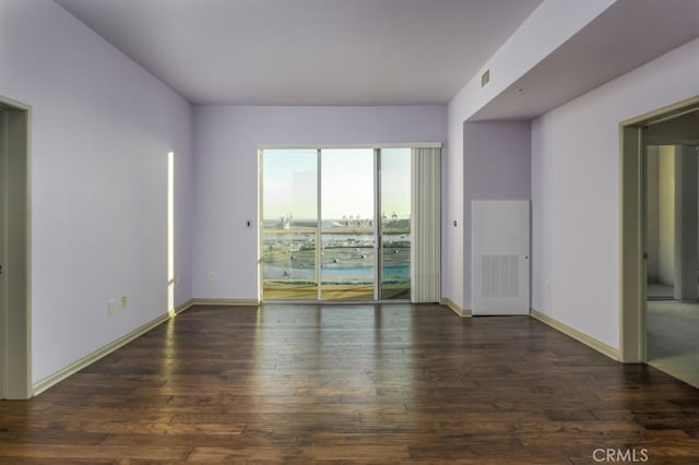 spare room featuring dark hardwood / wood-style floors