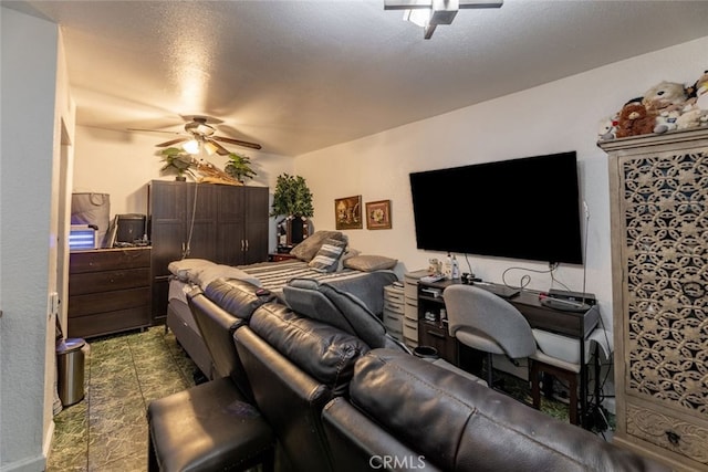 interior space with a textured ceiling and ceiling fan