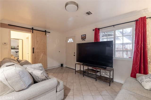 living room featuring a barn door, light tile patterned flooring, and crown molding