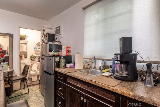 kitchen with dark brown cabinets and sink