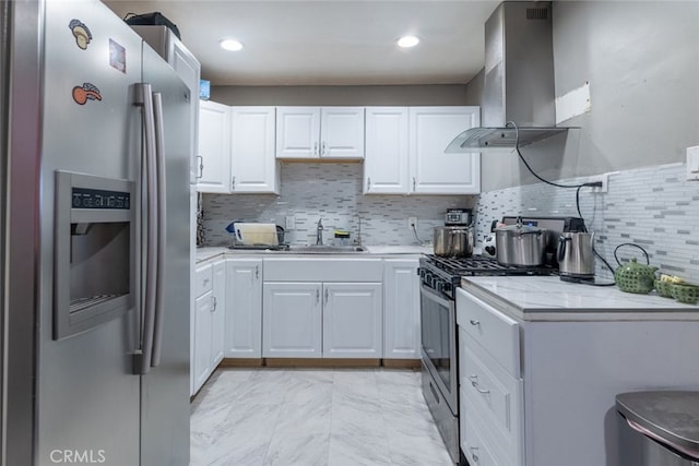 kitchen featuring white cabinetry, sink, range hood, and appliances with stainless steel finishes