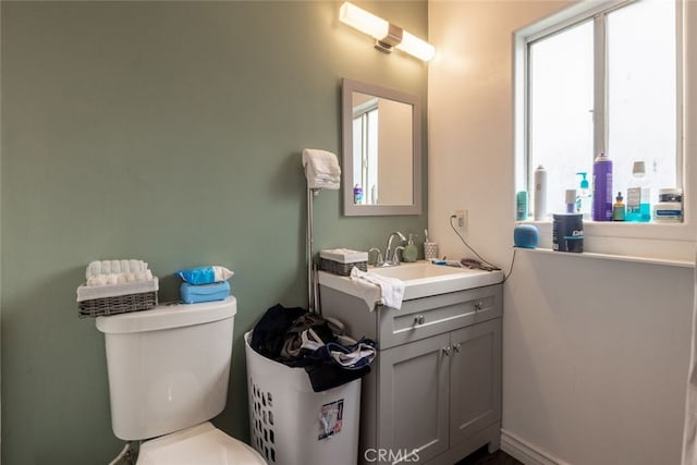 bathroom featuring vanity, toilet, and plenty of natural light