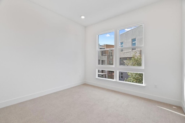 carpeted empty room featuring plenty of natural light