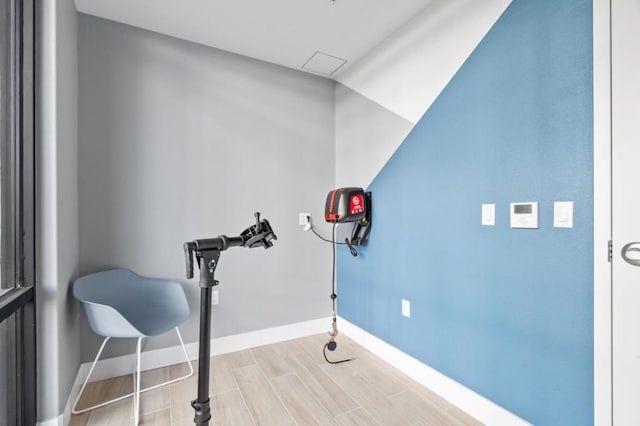 exercise room featuring light wood-type flooring