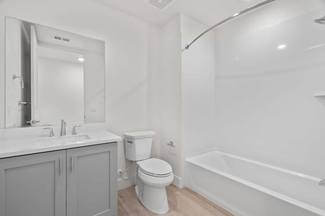 full bathroom with toilet, vanity, shower / bathing tub combination, and hardwood / wood-style flooring