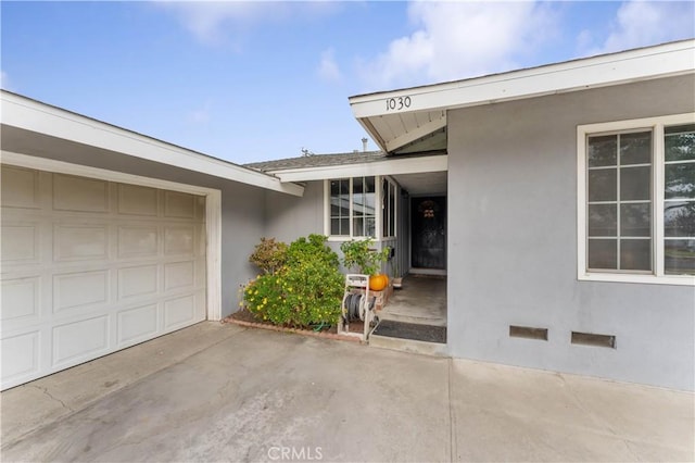 view of exterior entry with a garage