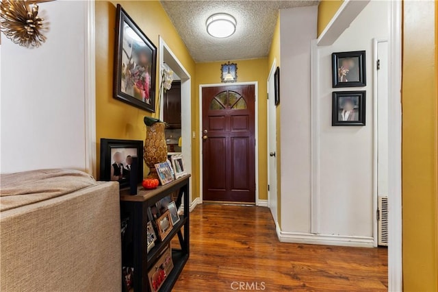 interior space with dark hardwood / wood-style floors and a textured ceiling