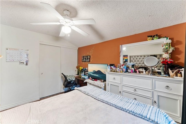 bedroom featuring a textured ceiling, ceiling fan, and lofted ceiling