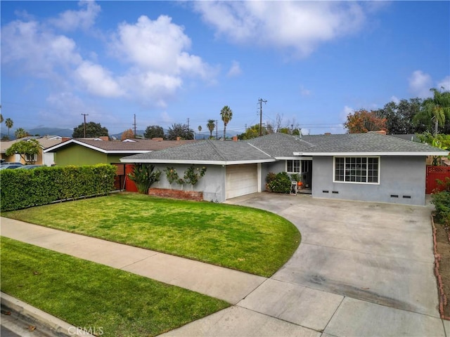 single story home featuring a garage and a front lawn