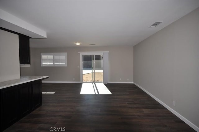 unfurnished living room with dark wood-type flooring