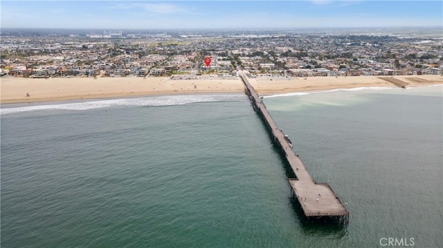 bird's eye view featuring a water view and a beach view