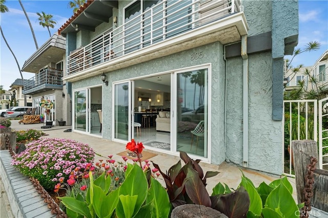 rear view of property with a balcony