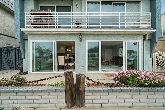 rear view of property with a balcony