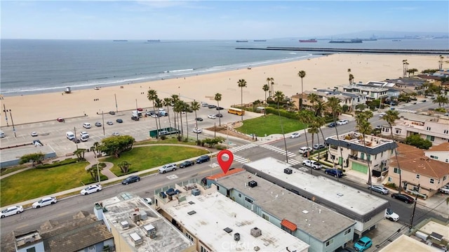 aerial view with a water view and a beach view