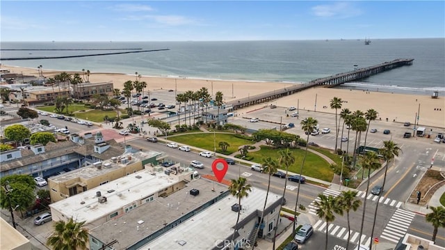 aerial view featuring a water view and a view of the beach