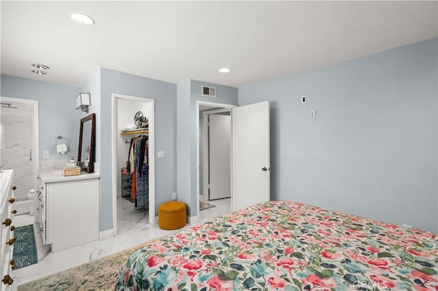 bedroom featuring a spacious closet and a closet