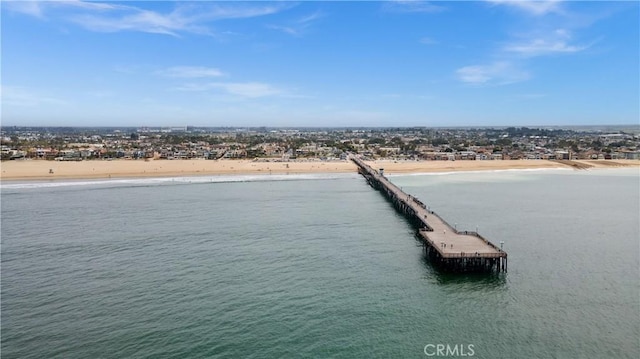 dock area featuring a beach view and a water view