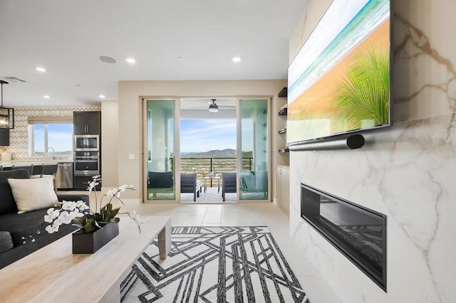 living room featuring sink and a high end fireplace