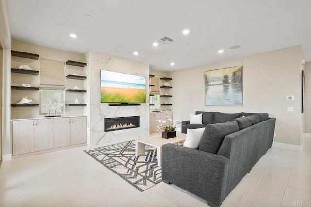 living room with a high end fireplace