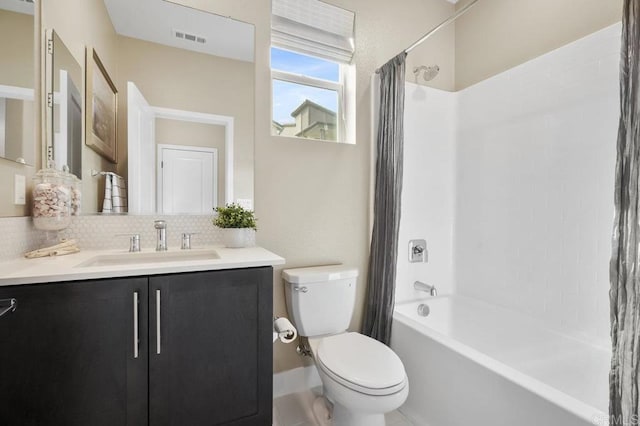 full bathroom with backsplash, vanity, shower / bath combo, and toilet