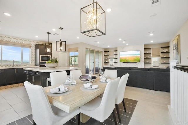 dining space featuring light tile patterned flooring and sink