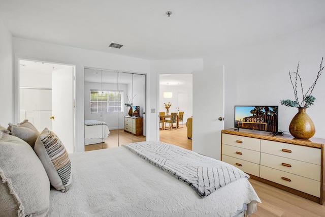 bedroom featuring a closet and light hardwood / wood-style flooring