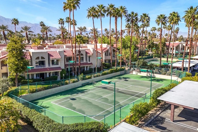 view of tennis court featuring a mountain view