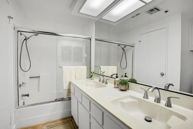 bathroom featuring enclosed tub / shower combo and vanity