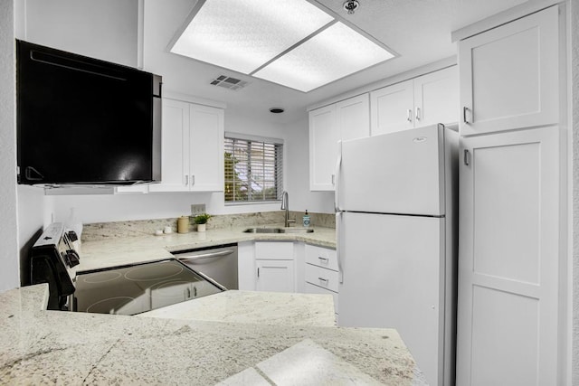 kitchen featuring dishwasher, sink, white cabinetry, range with electric stovetop, and white refrigerator