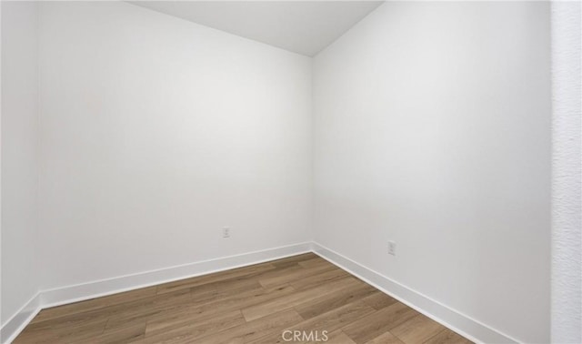 spare room with light wood-style floors and baseboards