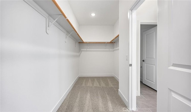 walk in closet featuring carpet