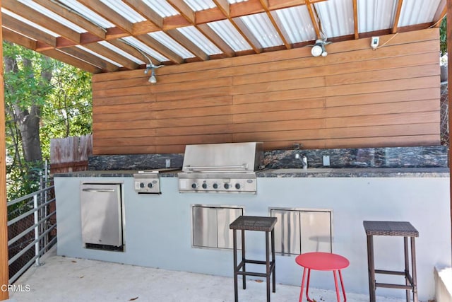 view of patio / terrace featuring area for grilling, a grill, and sink