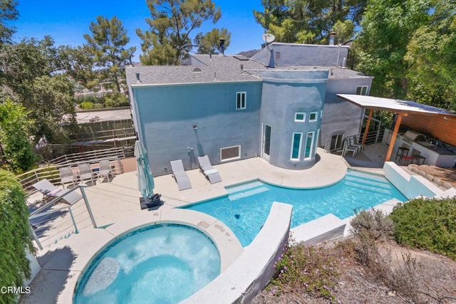 view of swimming pool featuring a diving board, an in ground hot tub, and a patio