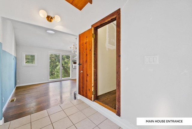 hall featuring light tile patterned flooring