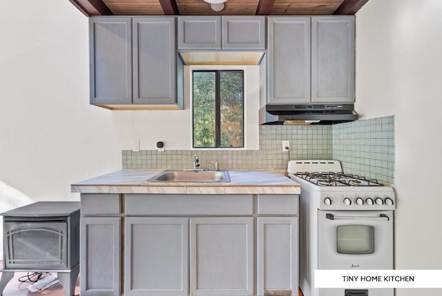 kitchen with gray cabinets, tasteful backsplash, sink, white gas range oven, and wooden ceiling