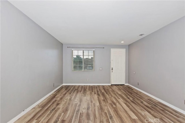 empty room with light hardwood / wood-style flooring