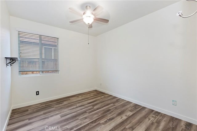 spare room featuring wood-type flooring and ceiling fan