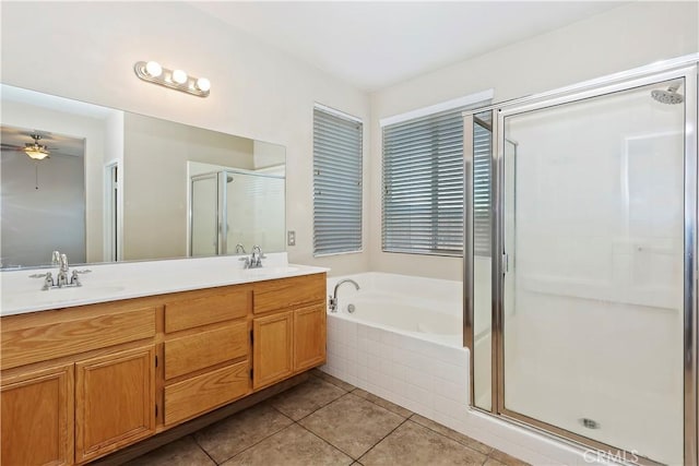 bathroom featuring tile patterned flooring, ceiling fan, vanity, and plus walk in shower