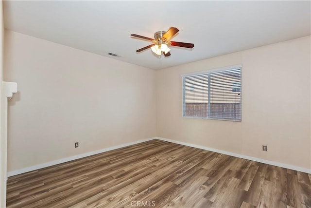 spare room with ceiling fan and wood-type flooring