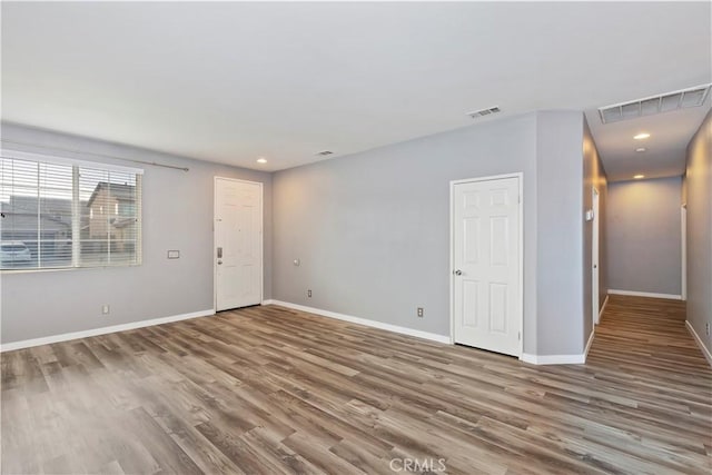 empty room with hardwood / wood-style floors