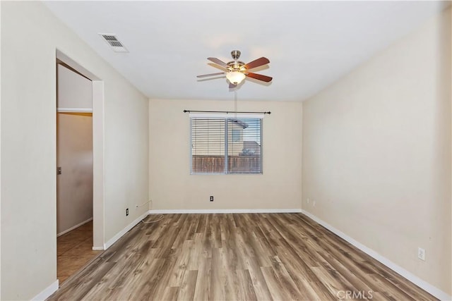 unfurnished room with ceiling fan and wood-type flooring